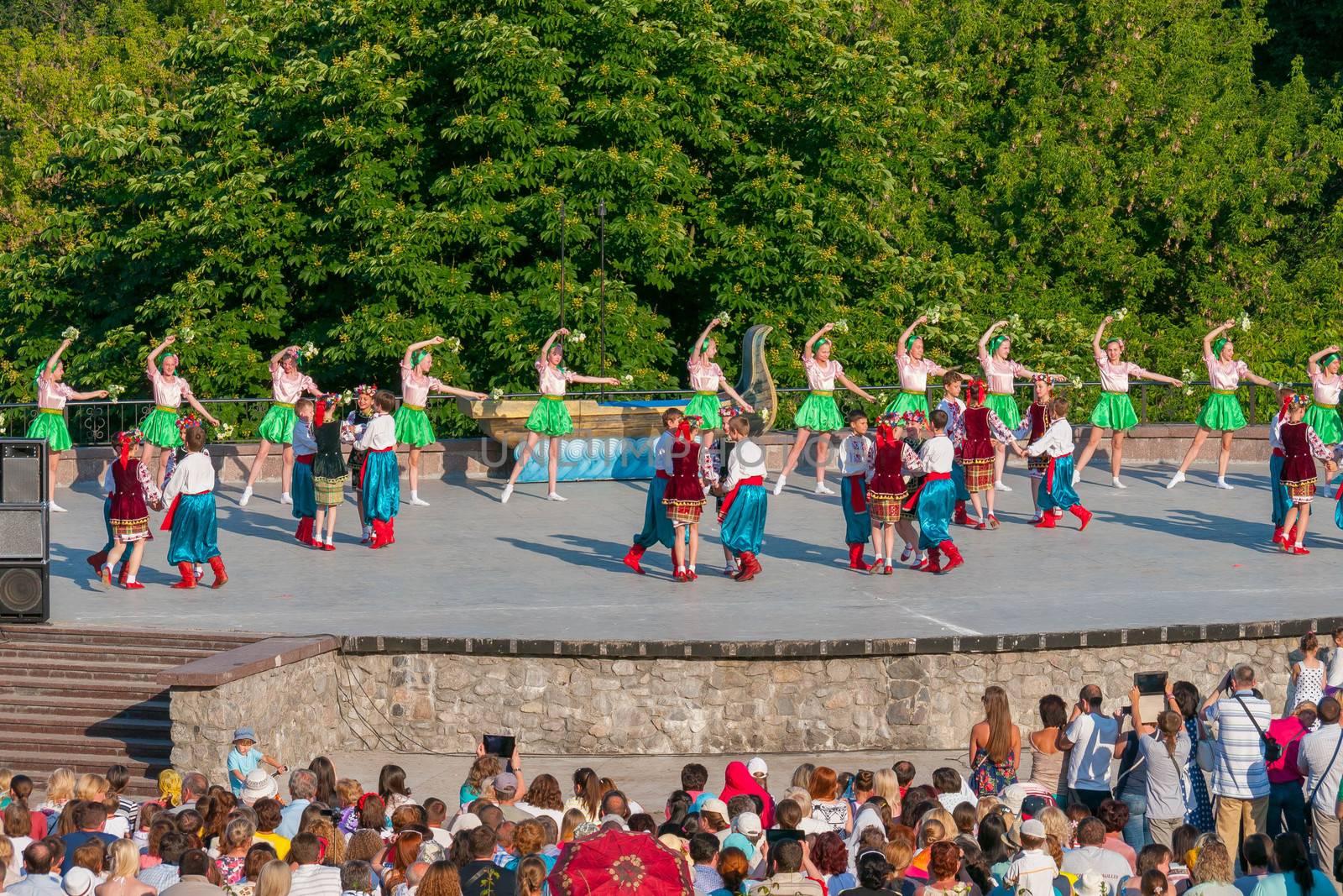 KIEV, UKRAINE - July 22 , 2016: Ukraina School of Dance Ensemble girls and boys dressed in traditional red Ukrainian embroidered costume clothes dancing