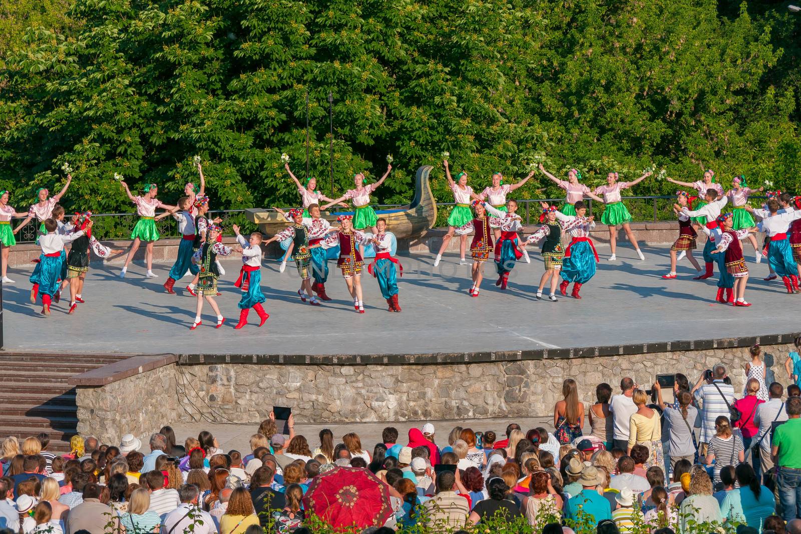 KIEV, UKRAINE - July 22 , 2016: Ukraina School of Dance Ensemble girls and boys dressed in traditional red Ukrainian embroidered costume clothes dancing