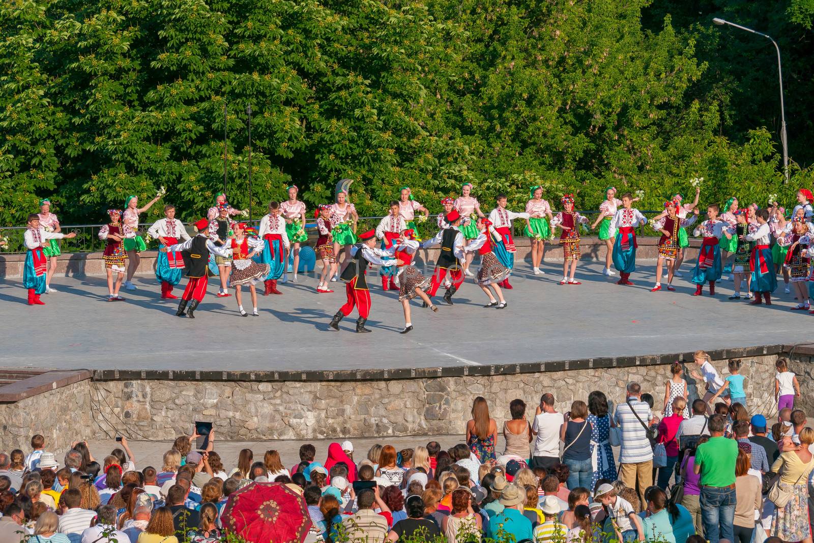 KIEV, UKRAINE - July 22 , 2016: Ukraina School of Dance Ensemble girls and boys dressed in traditional red Ukrainian embroidered costume clothes dancing