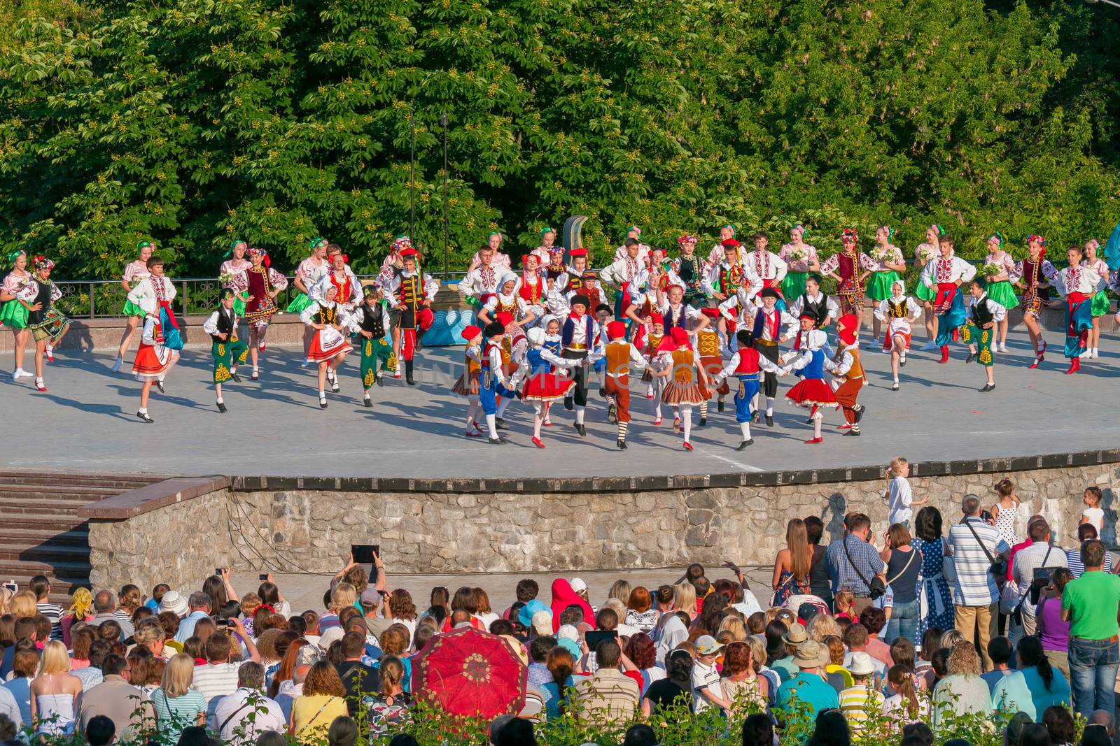 KIEV, UKRAINE - July 22 , 2016: Ukraina School of Dance Ensemble girls and boys dressed in traditional red Ukrainian embroidered costume clothes dancing