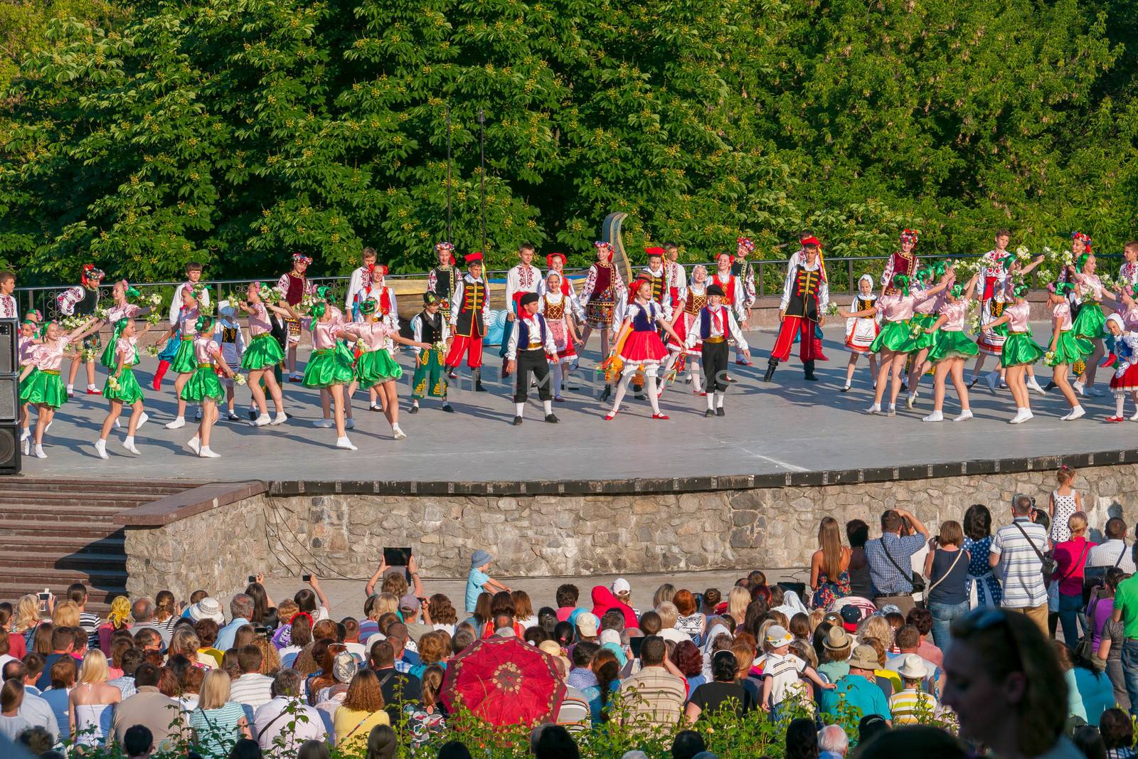 KIEV, UKRAINE - July 22 , 2016: Ukraina School of Dance Ensemble girls and boys dressed in traditional red Ukrainian embroidered costume clothes dancing
