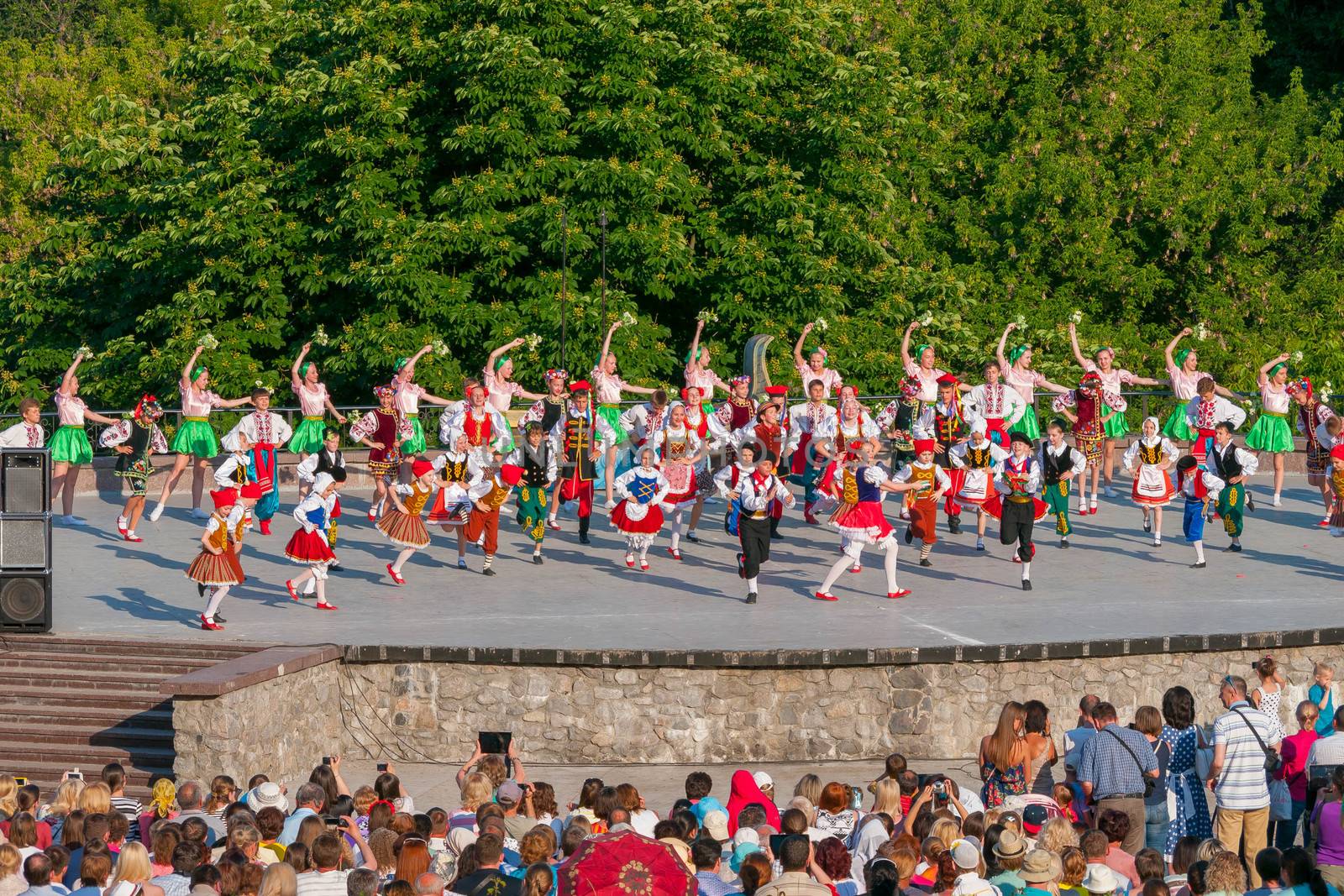 KIEV, UKRAINE - July 22 , 2016: Ukraina School of Dance Ensemble girls and boys dressed in traditional red Ukrainian embroidered costume clothes dancing