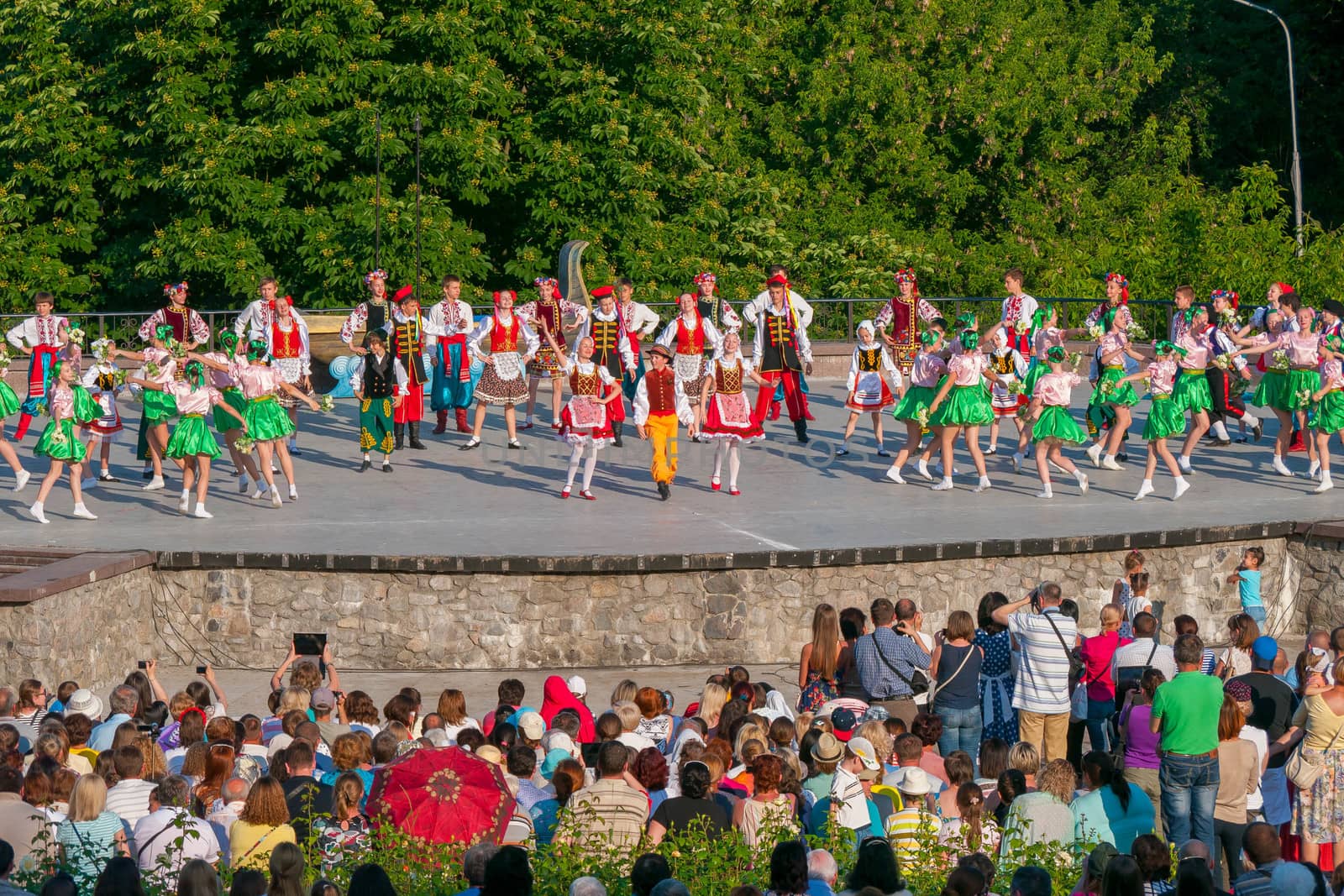 KIEV, UKRAINE - July 22 , 2016: Ukraina School of Dance Ensemble girls and boys dressed in traditional red Ukrainian embroidered costume clothes dancing