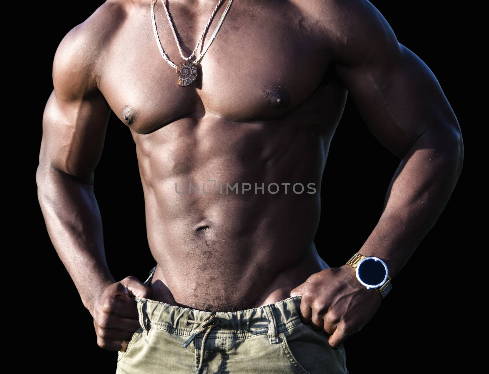 Torso of a handsome muscular shirtless African American man isolated over black background.