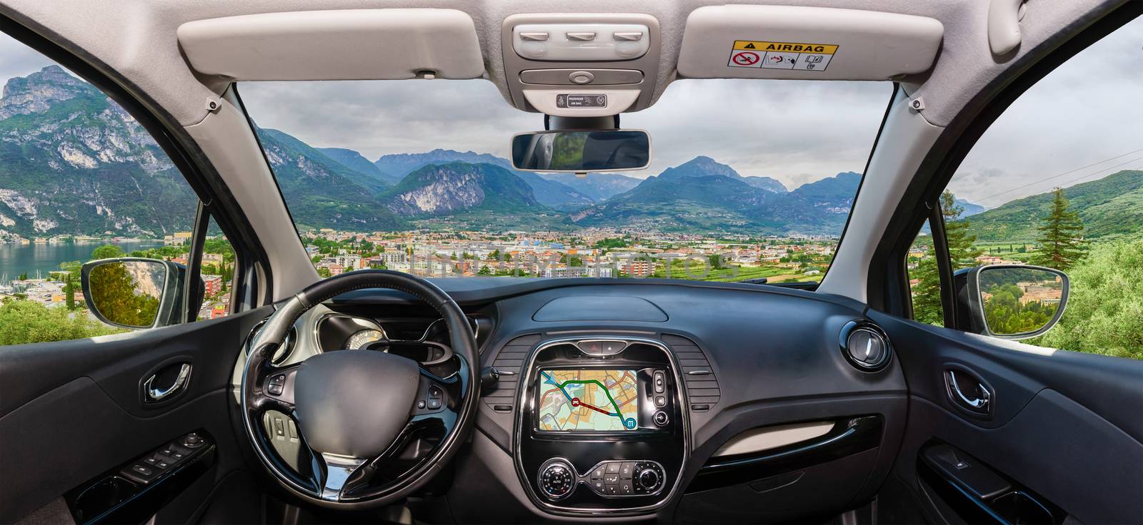 Car windshield view of Riva del Garda, Lake Garda, Italy by marcorubino