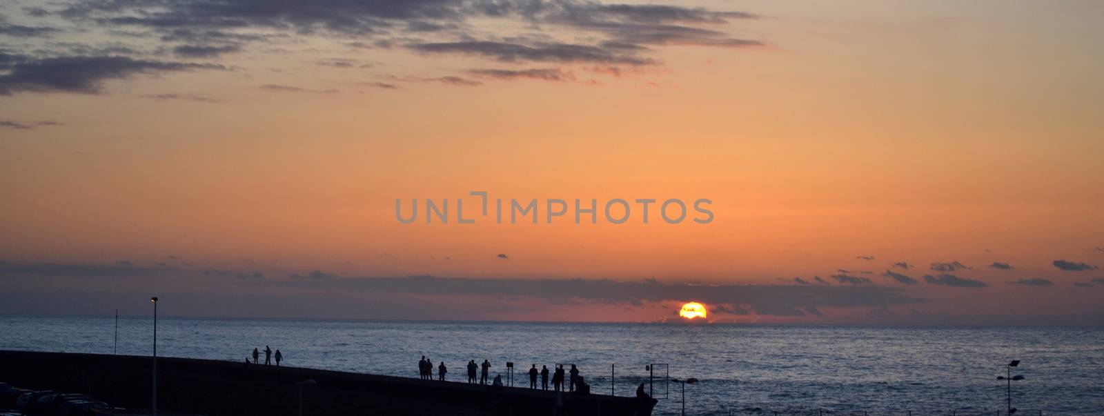 People watching the sunset on Atlantic Ocean shore by hibrida13
