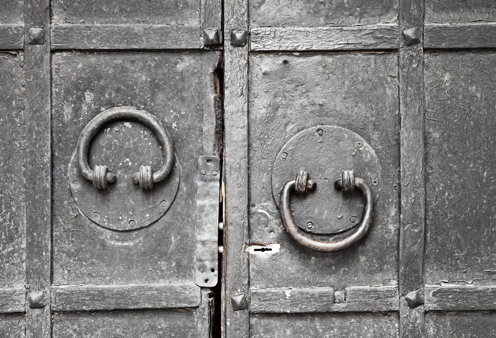 Ring-shaped door knocker on a metal gate