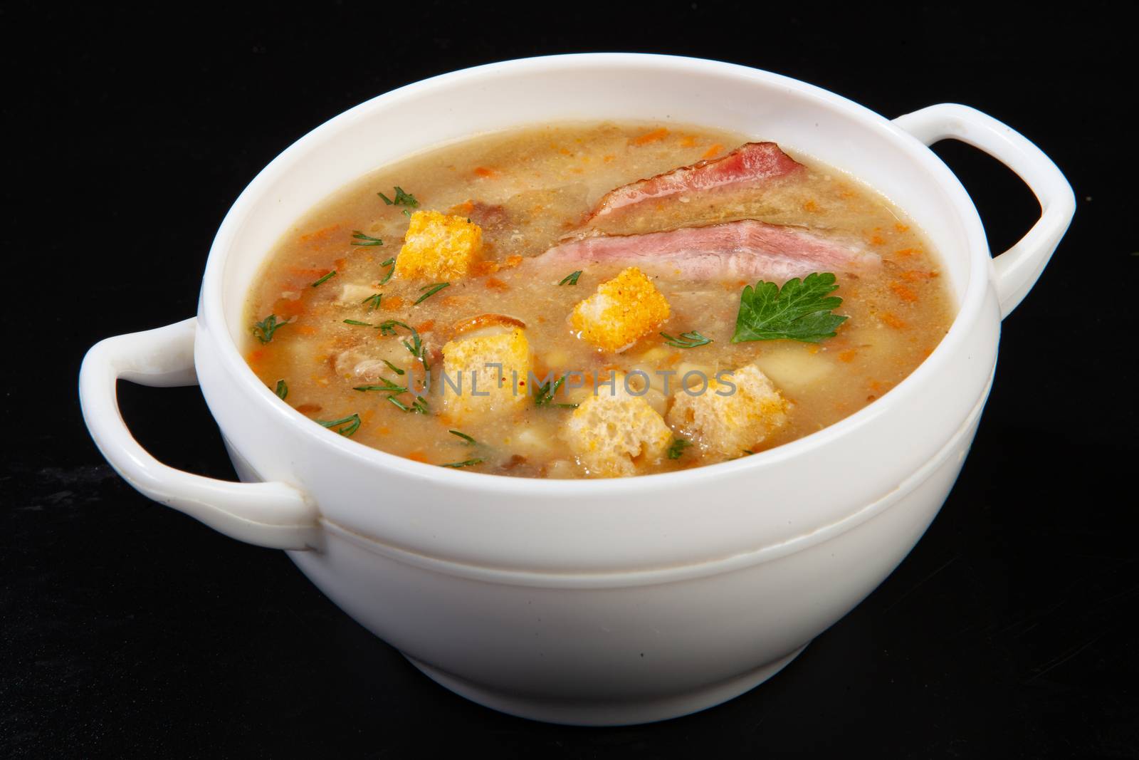 Porcelain plate with mushroom soup and beef