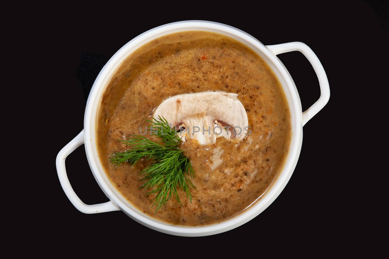 Porcelain plate with mushroom soup and beef