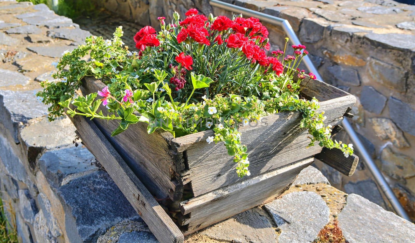 Old rustic wooden window box. Flowery background in Europe. Czech Republic, South Moravia by roman_nerud