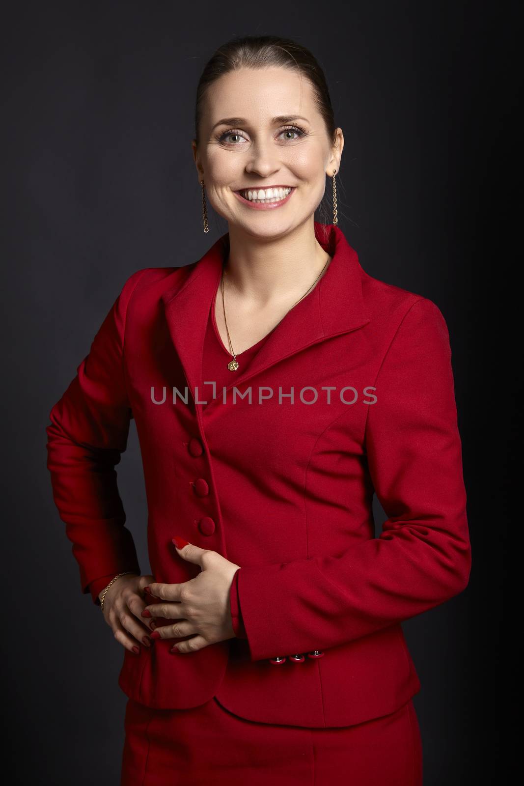 Studio shot of attractive young woman with a sincere smile on black background.