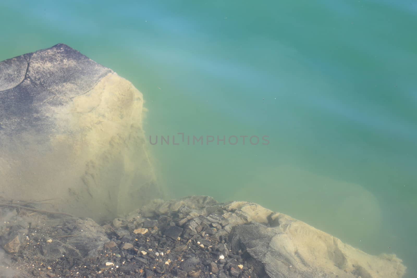 Basalt rock under water. Beautiful geological lake