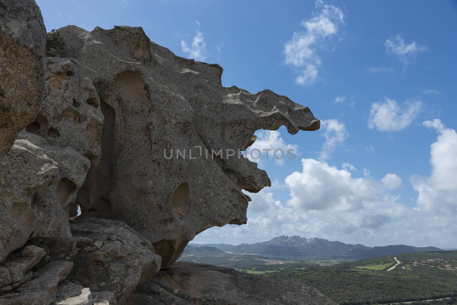 rocks and blue ocean seen from capo orso in sardinia italy, with la maddalena as background,capo dorso is a landmark wth beautifull rocks at the costa emeralda