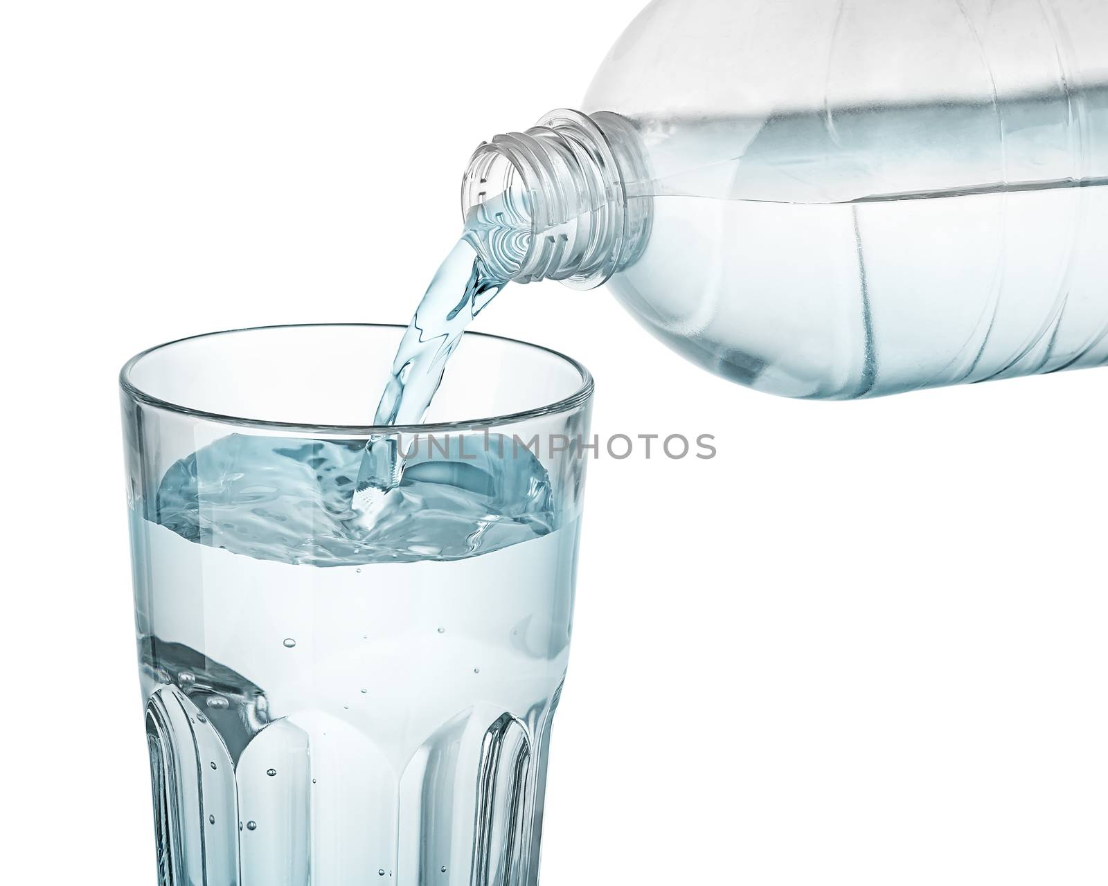 Water is poured into a glass. Plastic bottle. Isolated on white background.