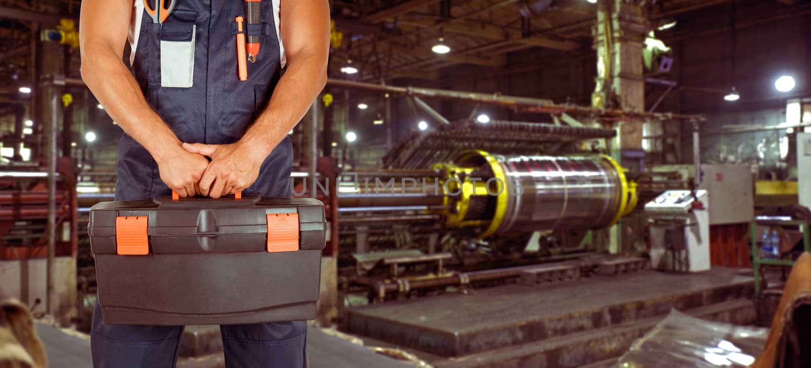 Worker with instruments at industrial factory