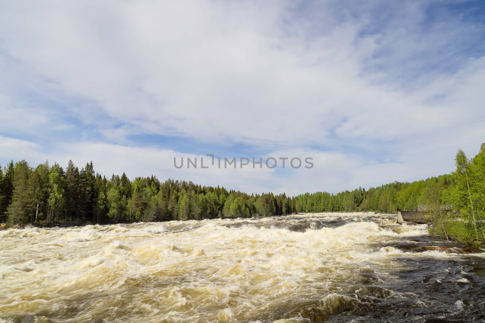 The rapids at Renforsen in Vindeln, Sweden with a partly cloudy sky.
