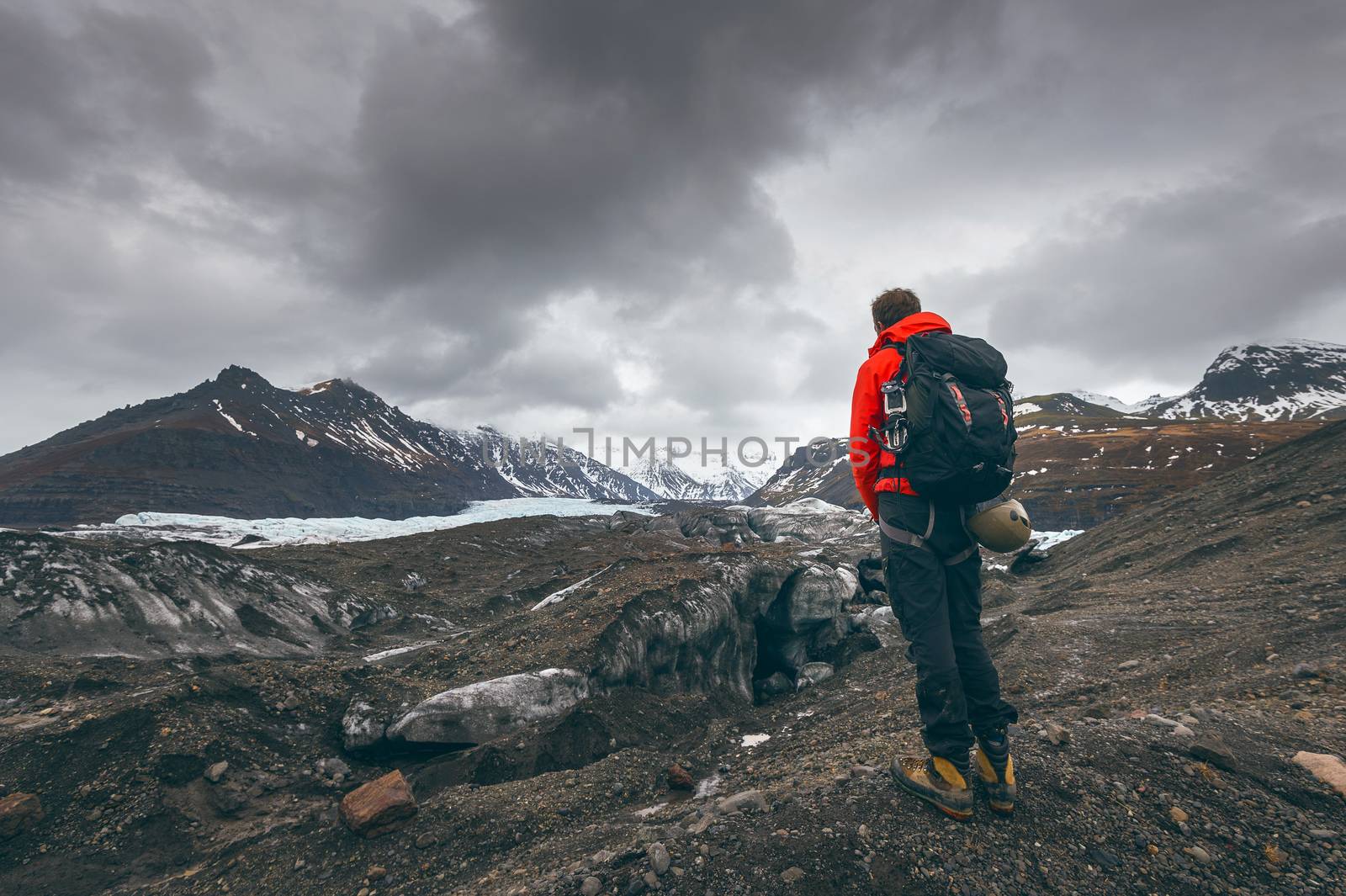 Hiking adventure travel man watching glacier in Iceland. by gutarphotoghaphy