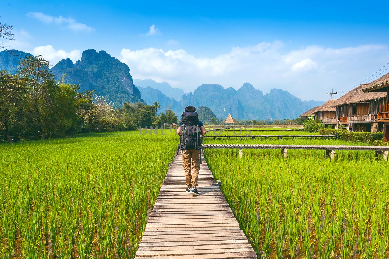 Tourism with backpack walking on wooden path, Vang vieng in Laos by gutarphotoghaphy