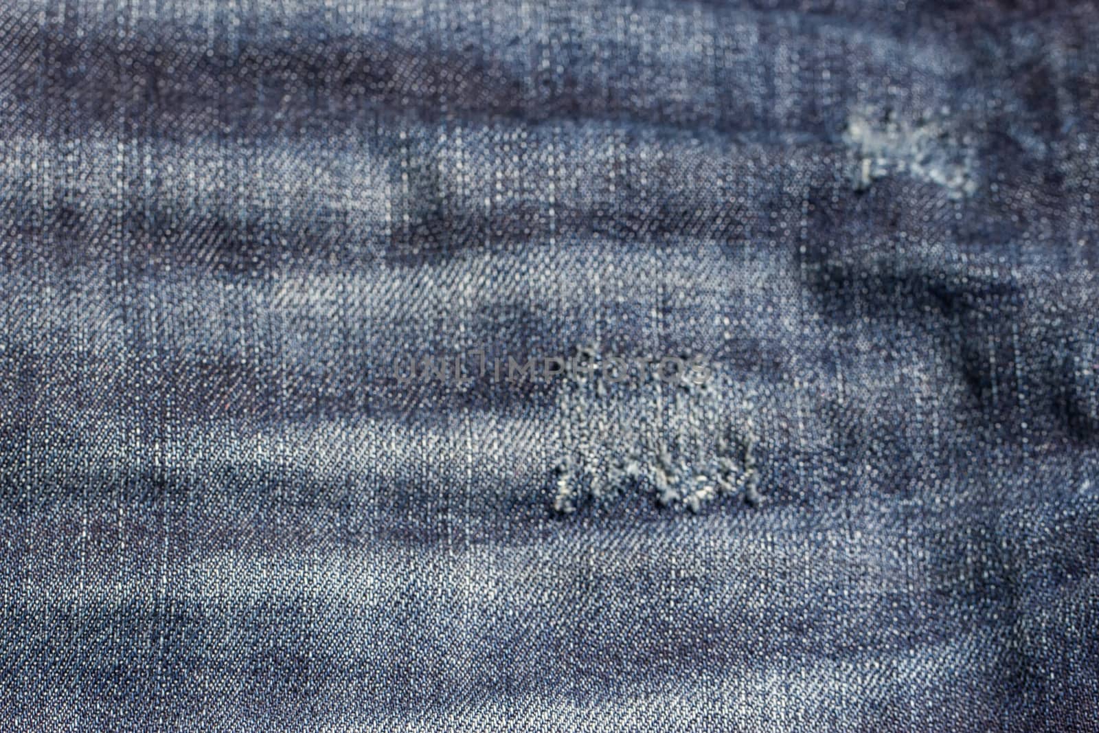 the blue Jeans torn denim texture with hole