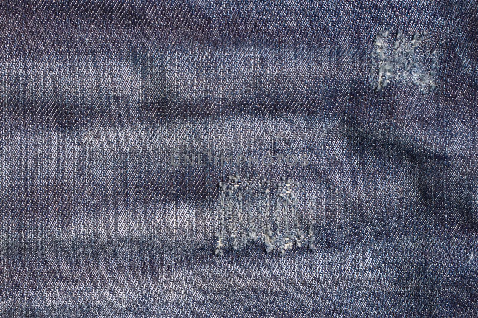 the blue Jeans torn denim texture with hole
