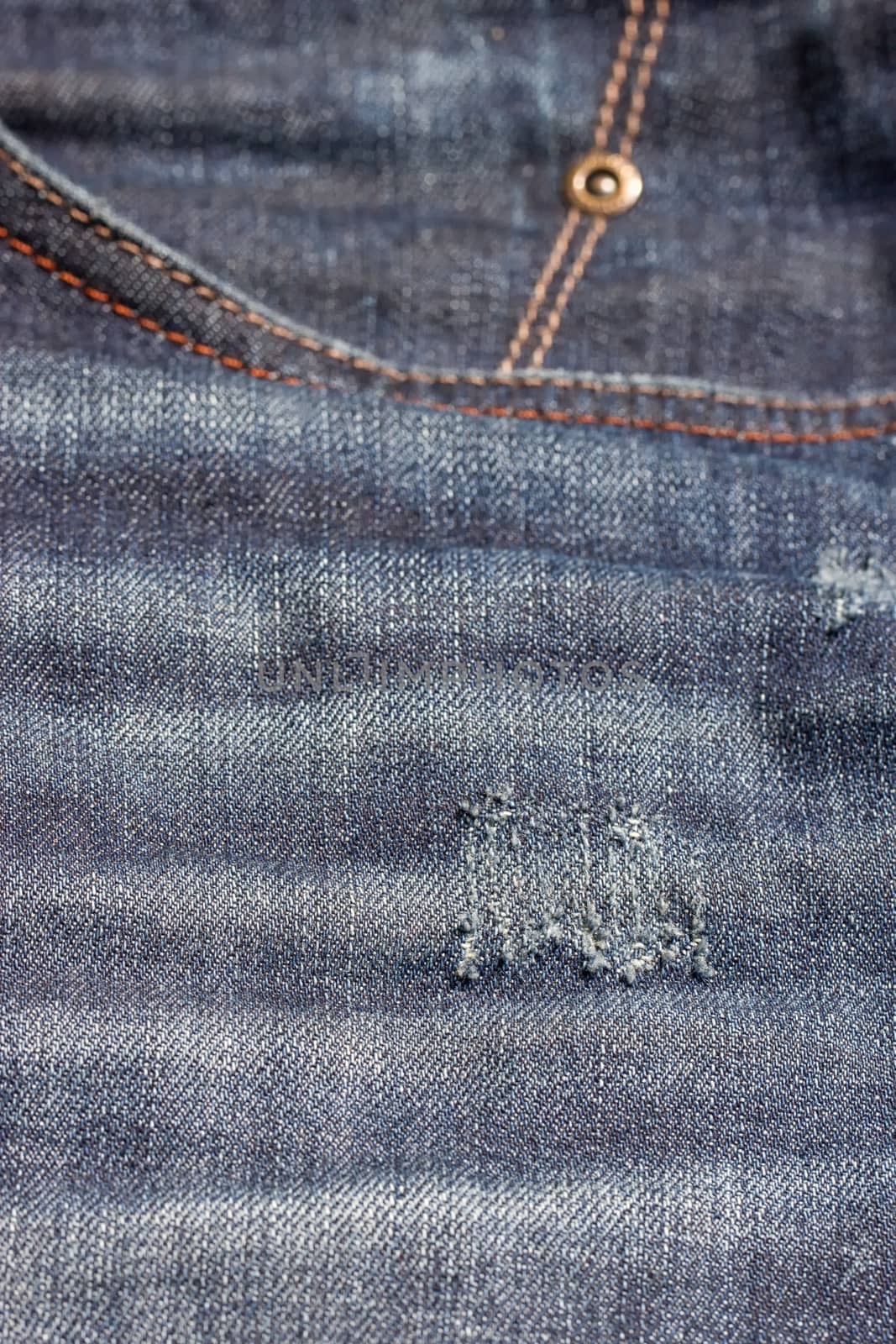 Blue jeans pocket with scuffs. Denim texture