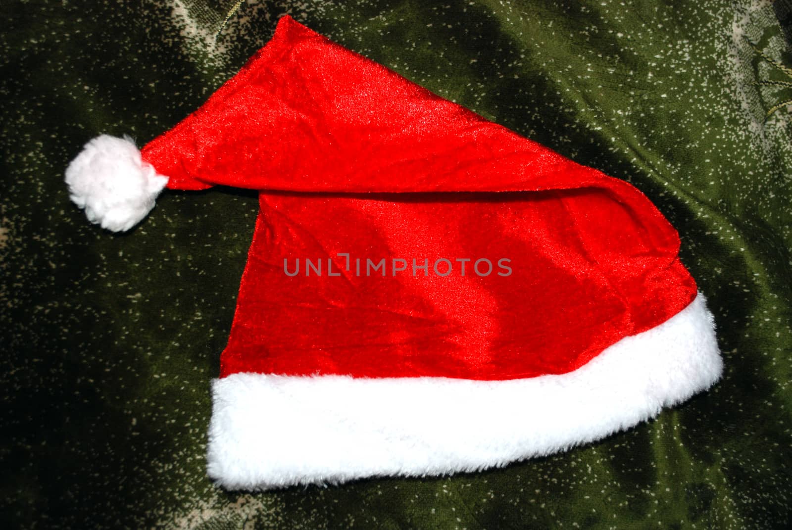 red Christmas hat on a green background