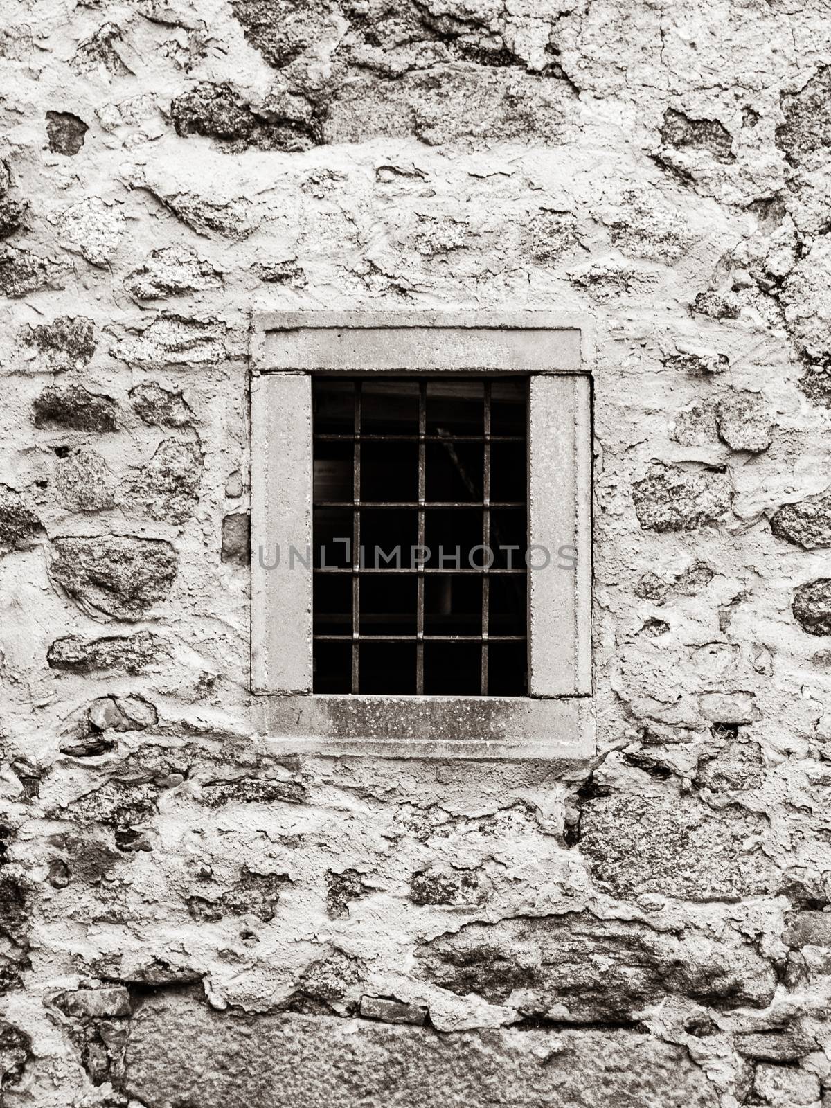 Old prison jail window with rusty metal bars. Vintage style image by pyty