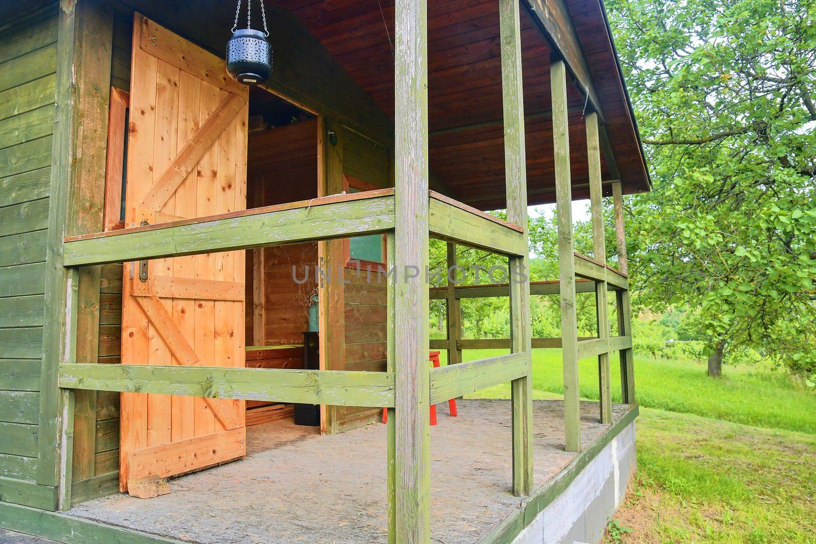 Wooden garden shed in a beautiful rural orchard. Close-up.