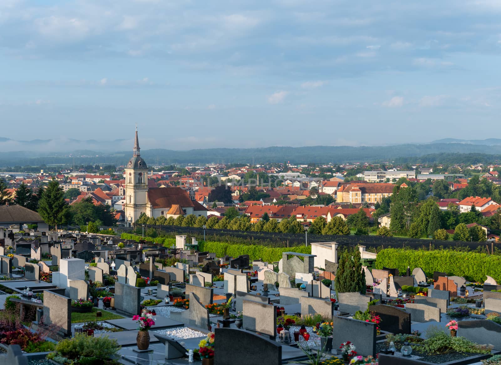 Panoramic view of Slovenska Bistrica, Slovenia, the church of St. Bartholomew dominates the towns skyline, cemetery in front