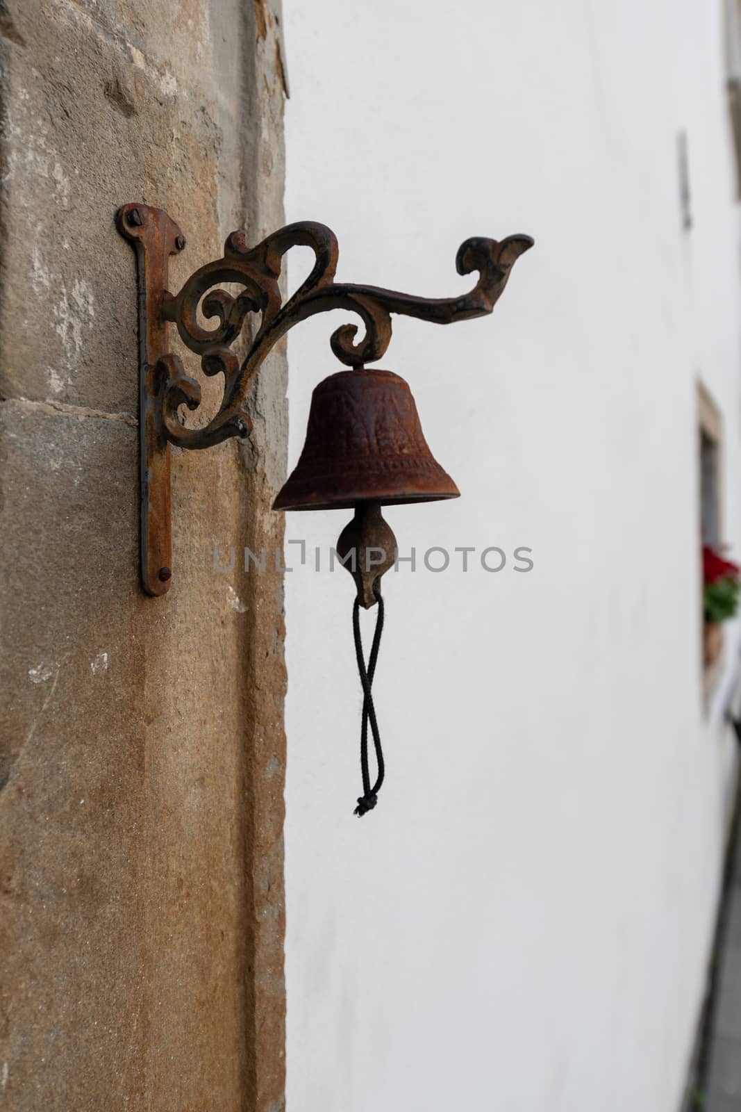 Vintage old metal bell hang on stone arch, background captured in front view