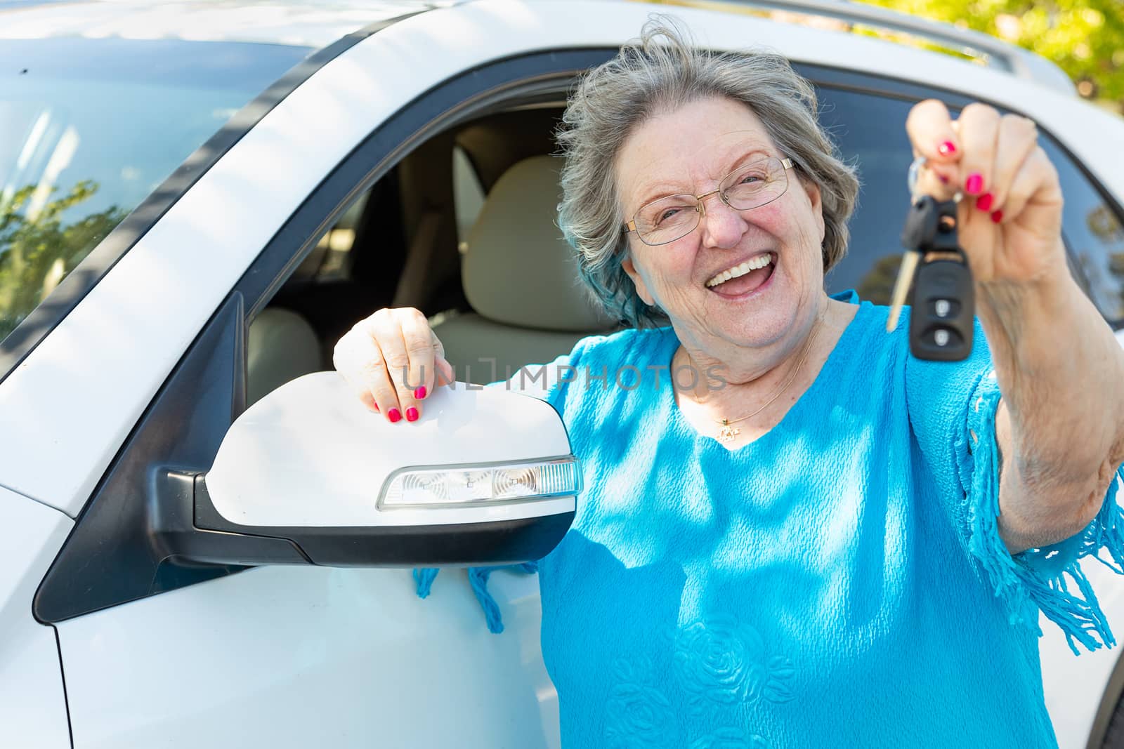 Happy Senior Woman With New Car and Keys.