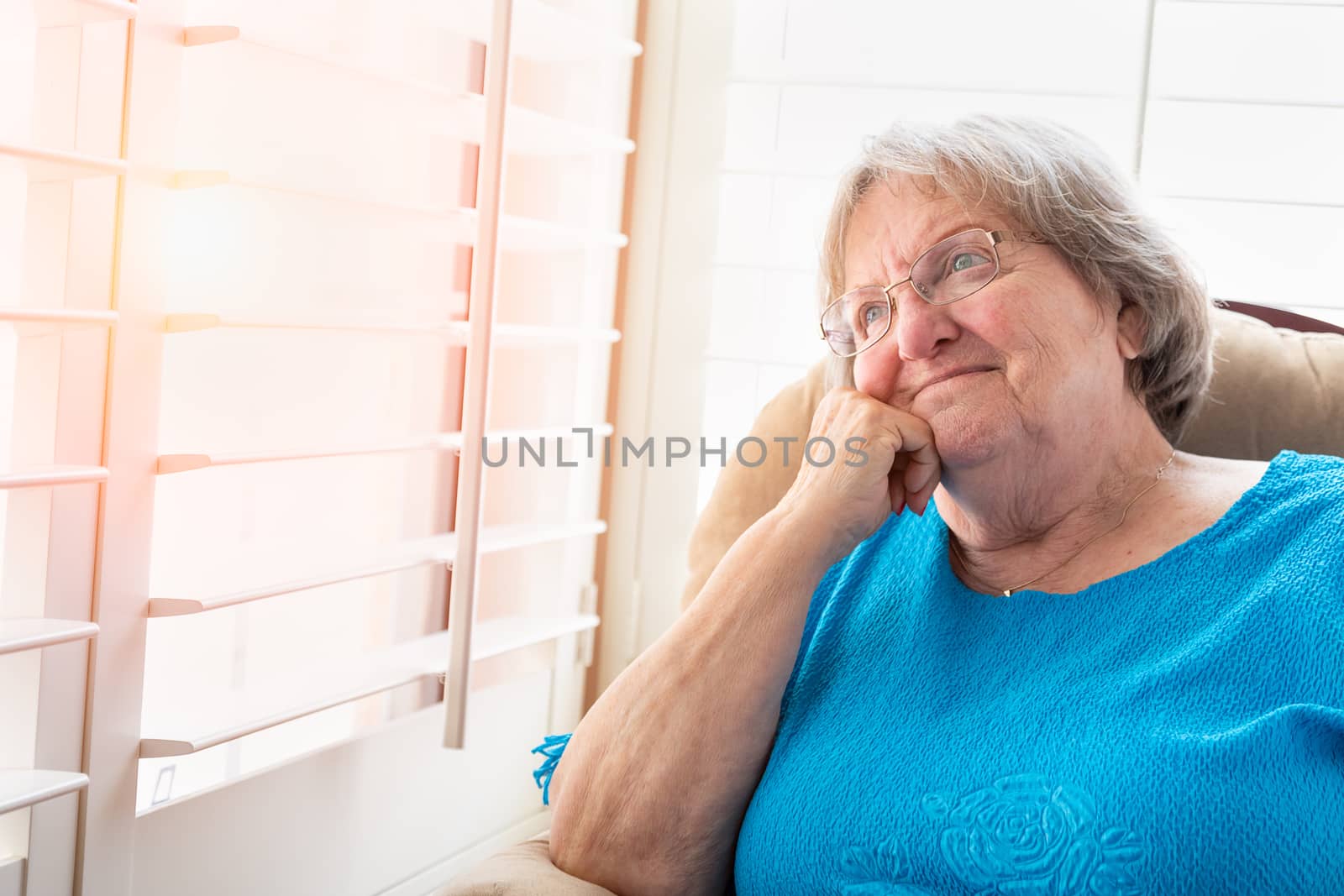 Content Senior Woman Gazing Out of Her Window. by Feverpitched