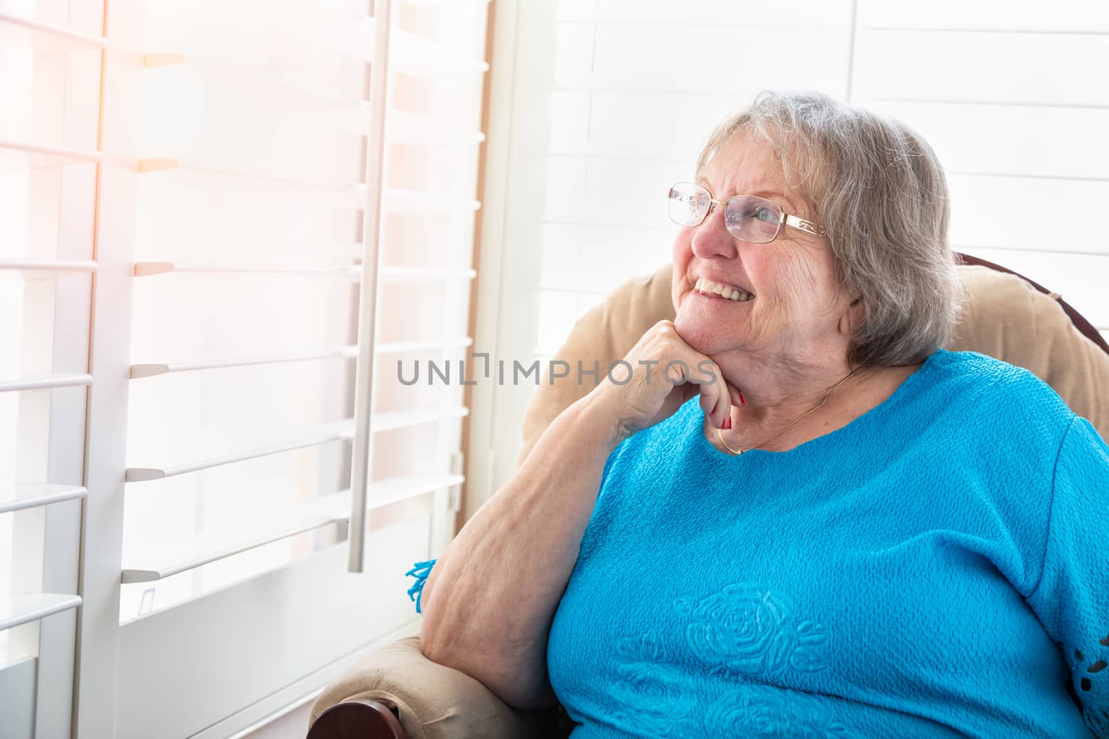 Content Senior Woman Gazing Out of Her Window.