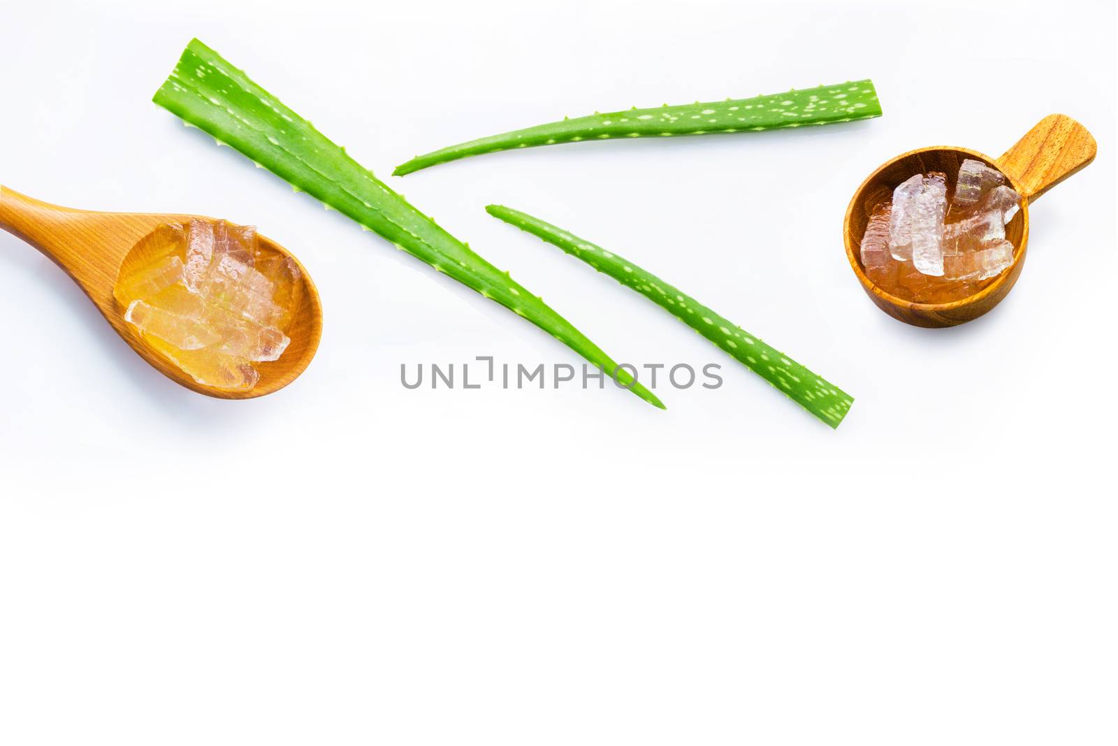 Aloe vera fresh leaves with aloe vera gel on wooden spoon. isolated on white