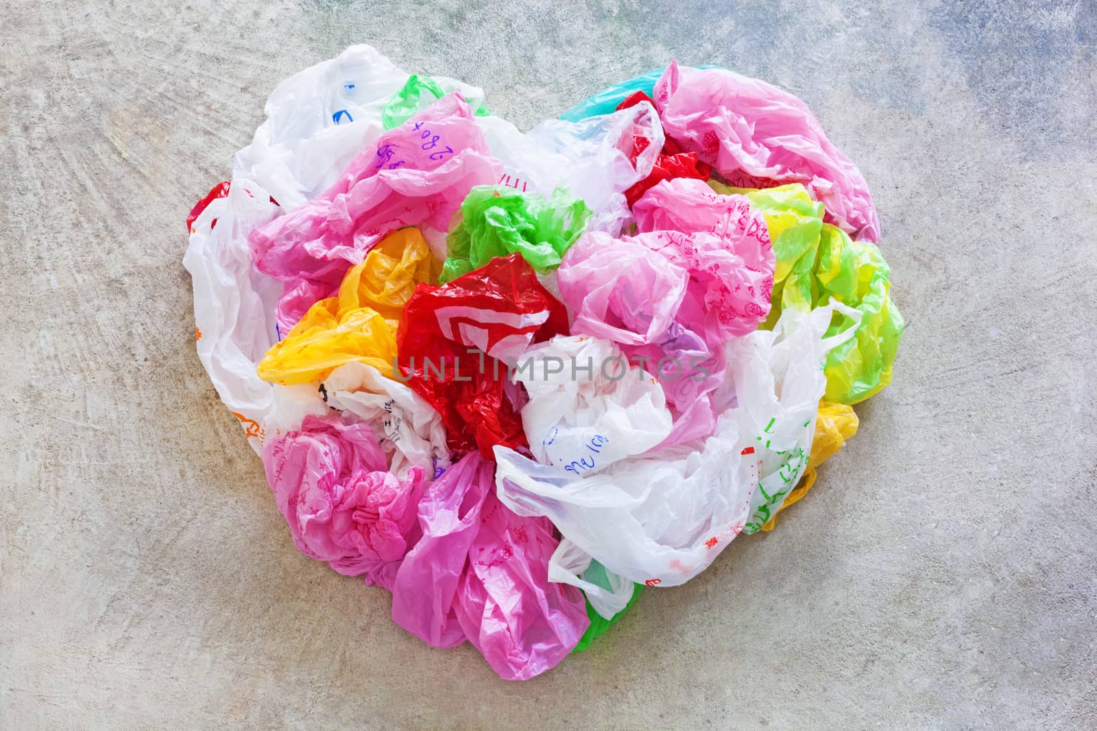 Colorful plastic bag on cement floor background. Heart Shape