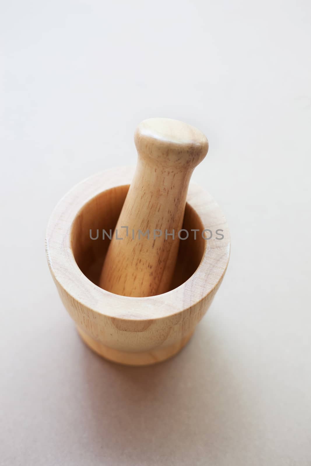 Brown wooden mortar on white background.