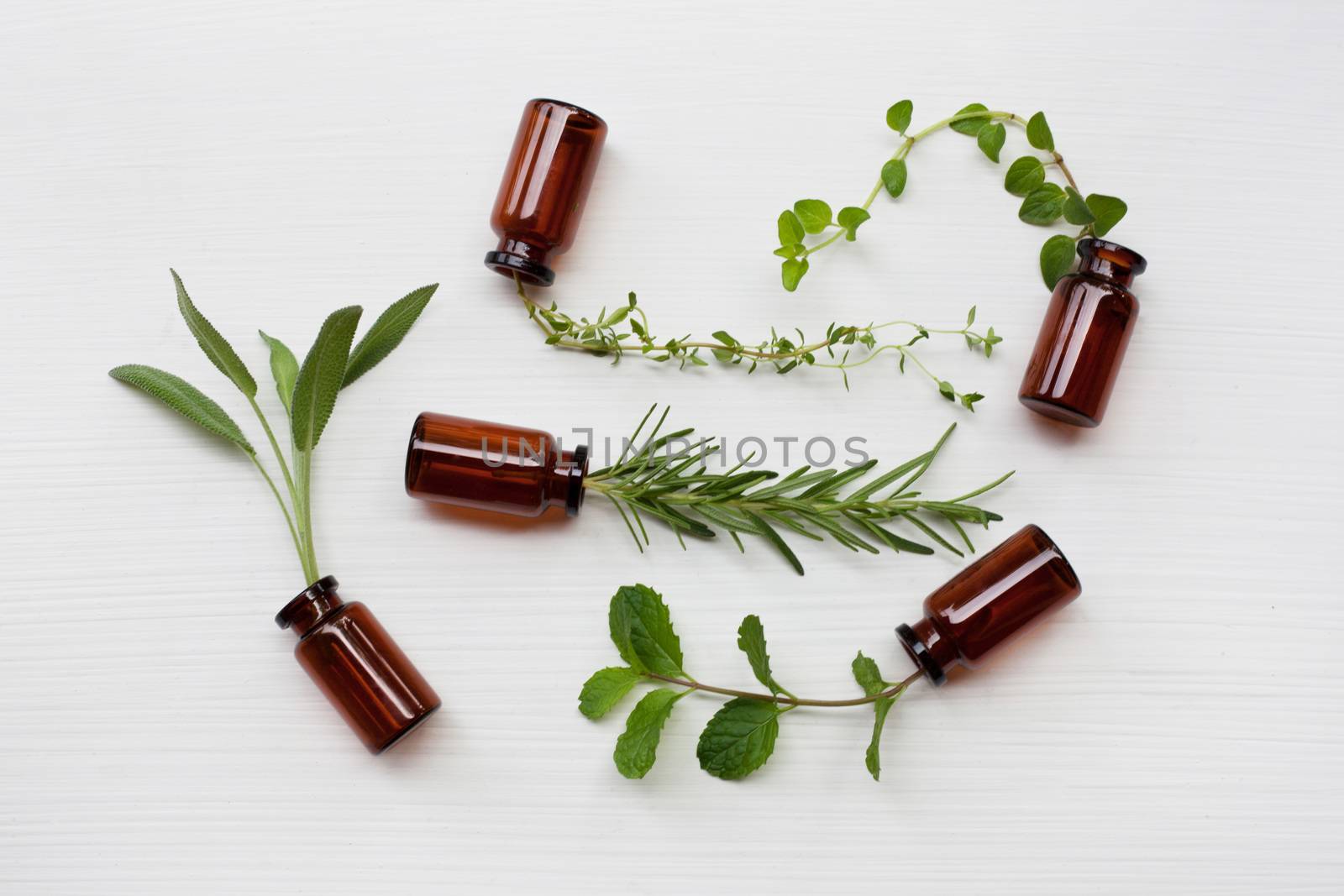 Top view, Bottle of essential oil with herbs