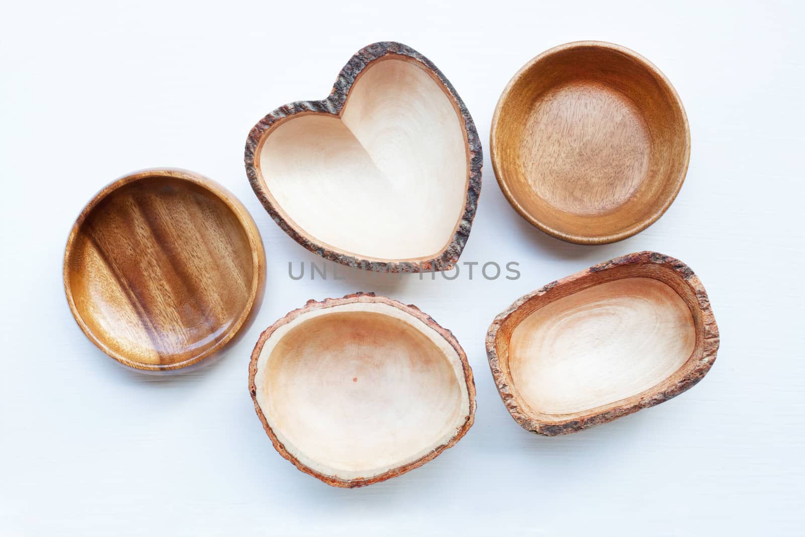 Empty wooden dish on white wooden background.
