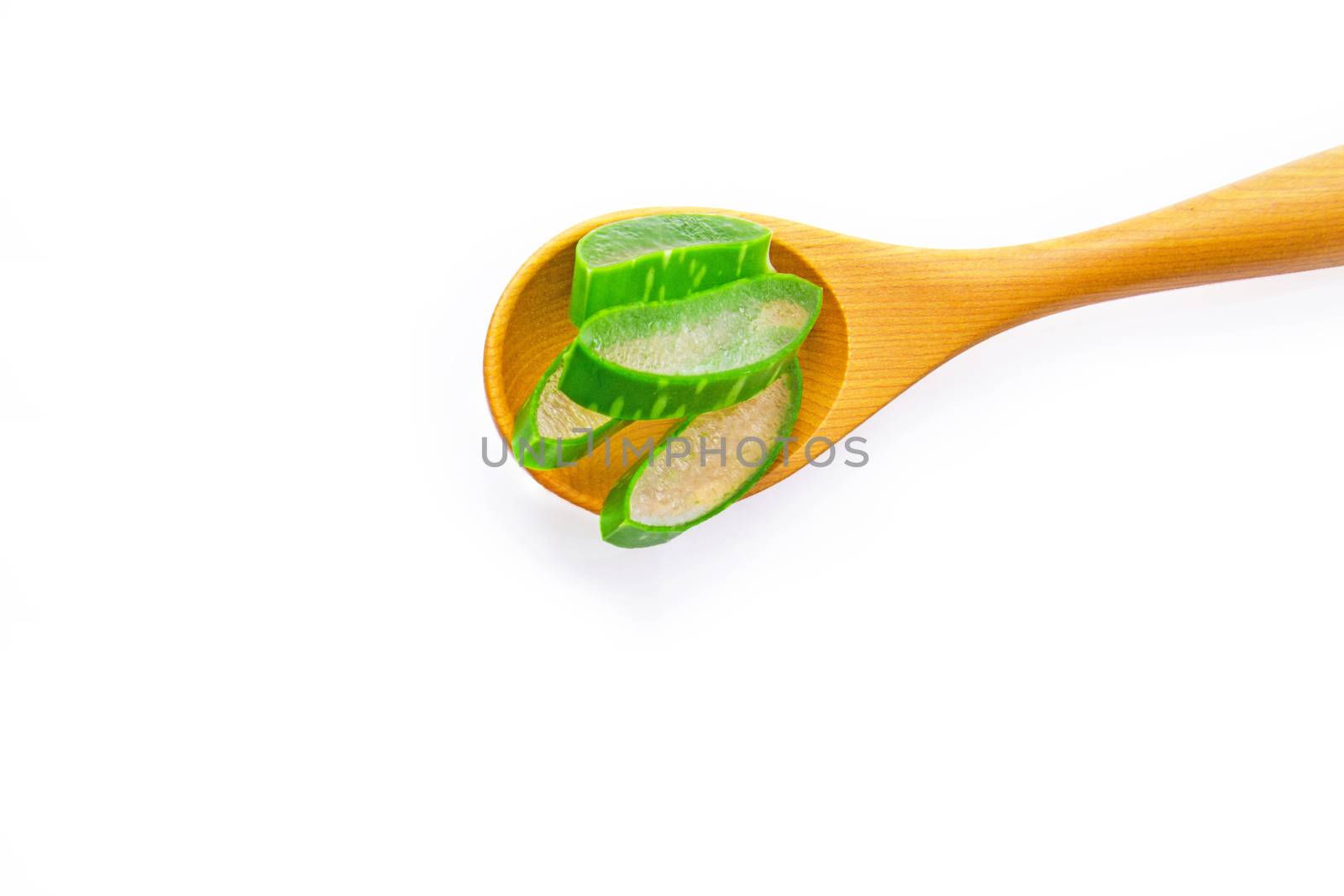 Aloe vera fresh leaves with aloe vera gel on wooden measuring spoon. isolated over white