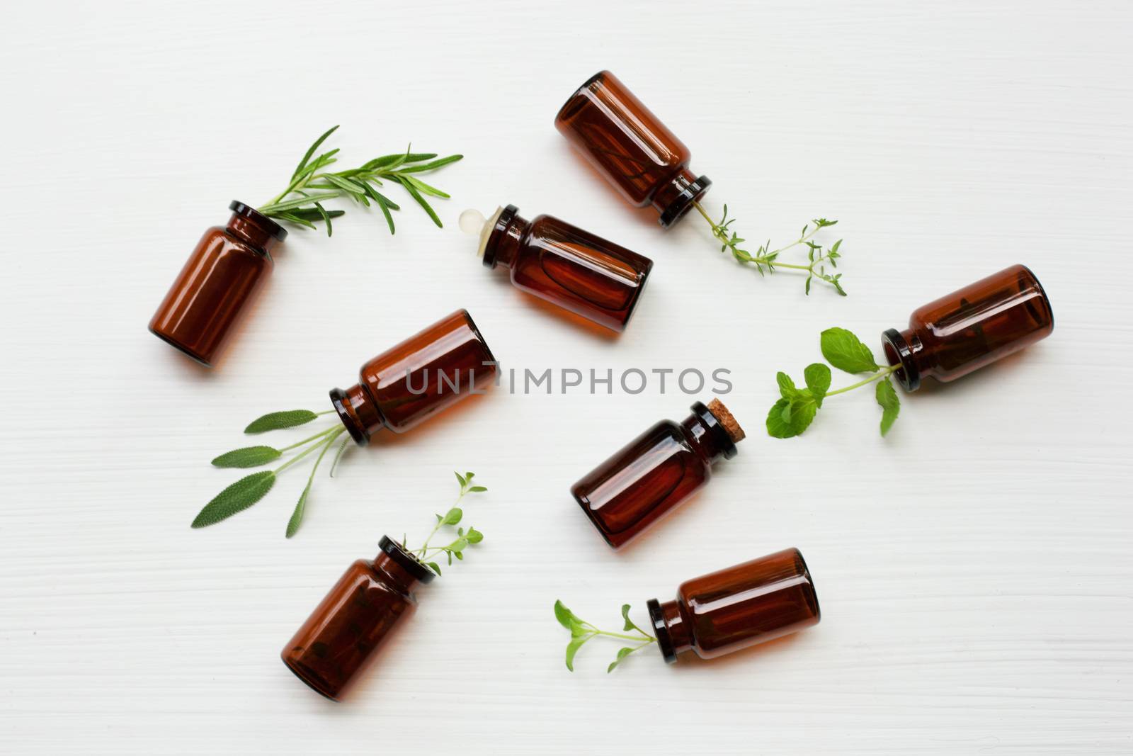 Top view, Bottle of essential oil with herbs