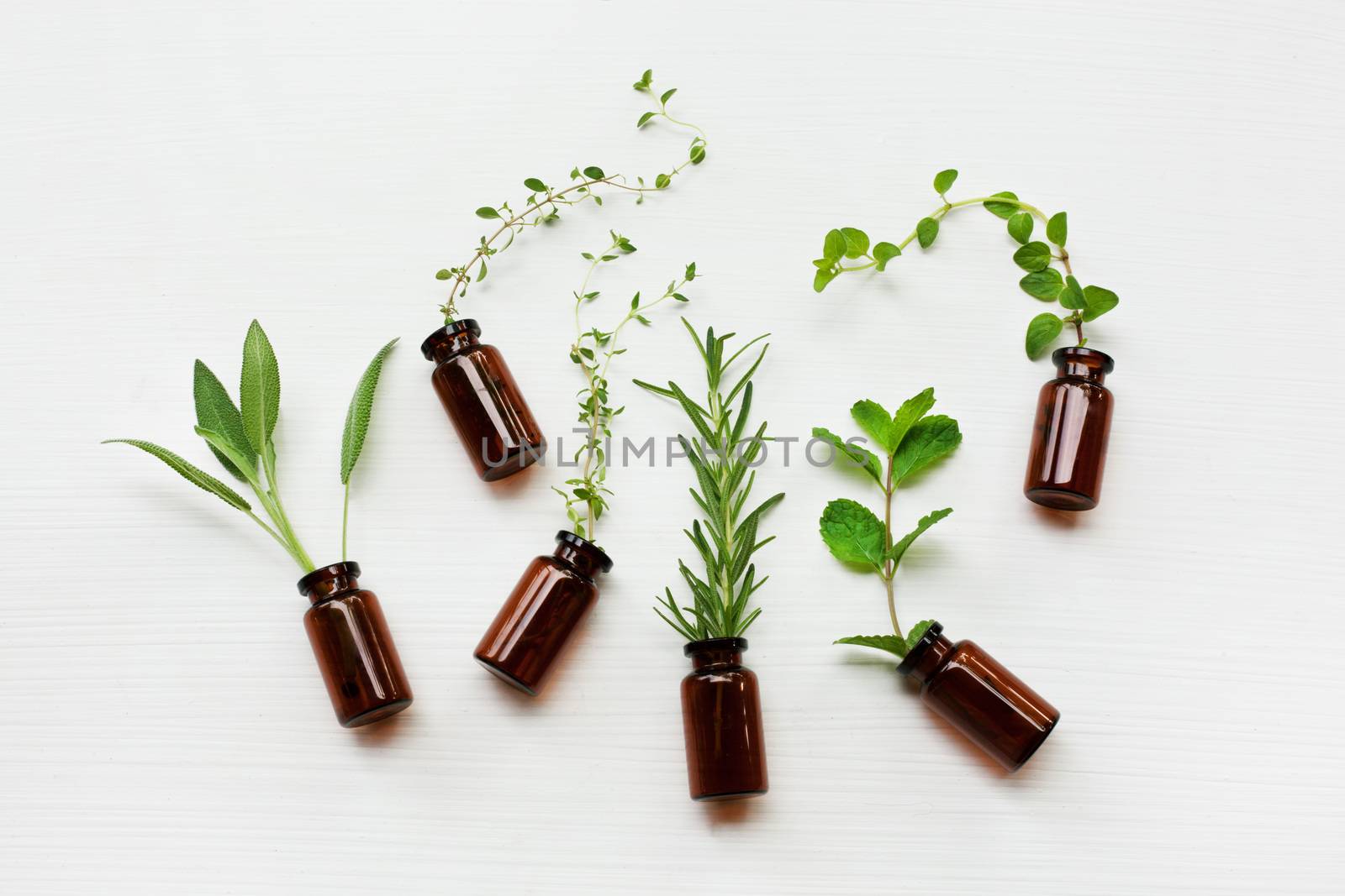 Top view, Bottle of essential oil with herbs