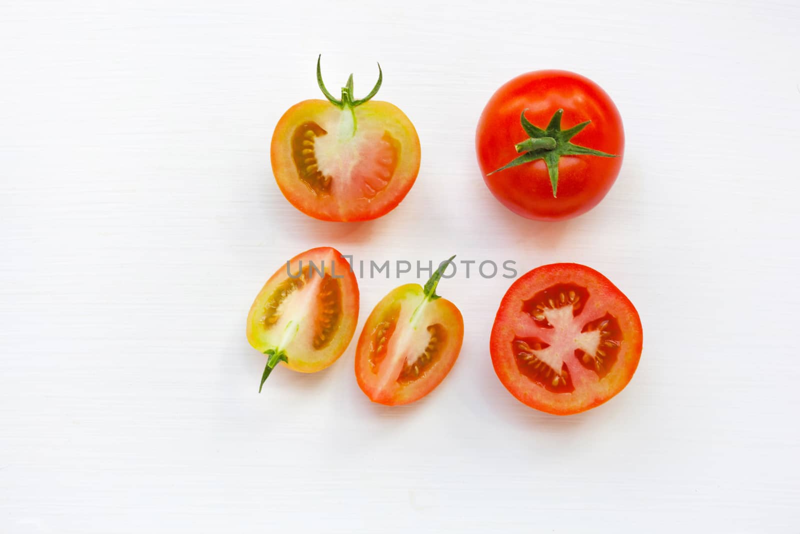 Fresh tomatoes on white wooden background. Top view