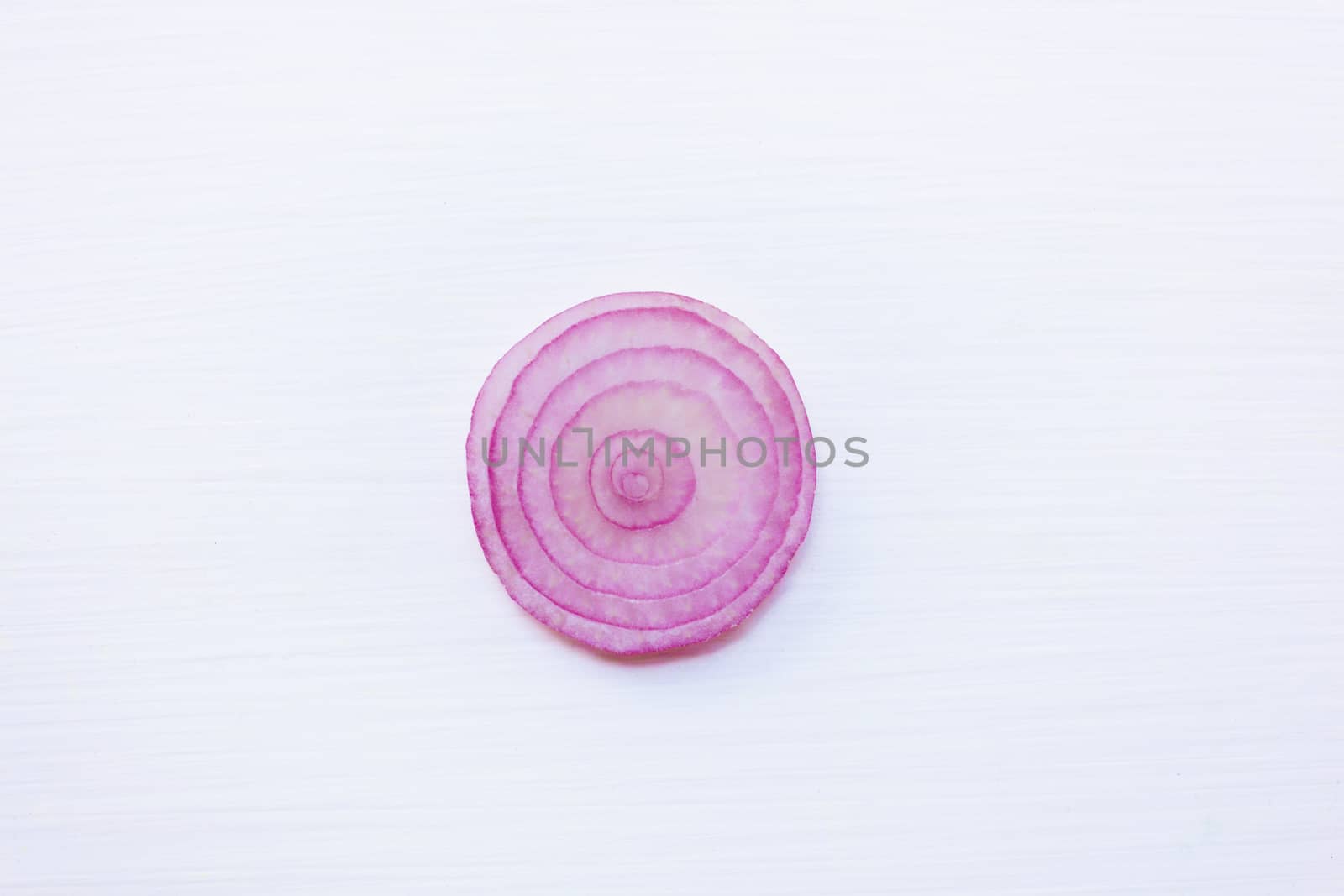 Slices of red onion on  white background. Top view