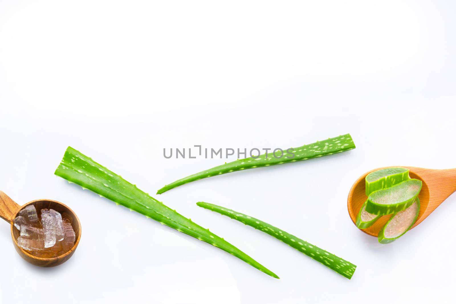 Aloe vera fresh leaves with aloe vera gel on wooden spoon. isolated on white