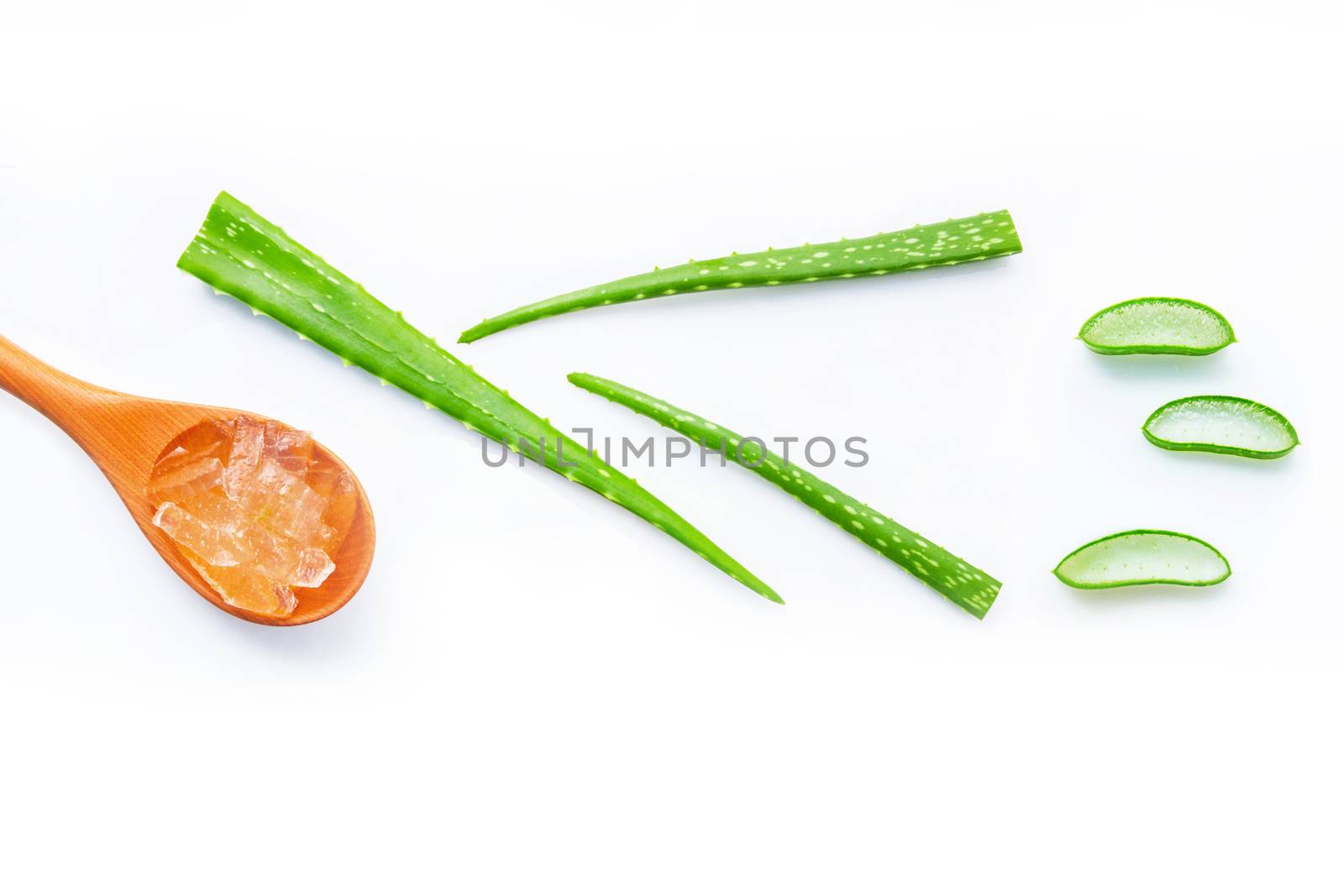 Aloe vera fresh leaves with aloe vera gel on wooden spoon. isolated on white