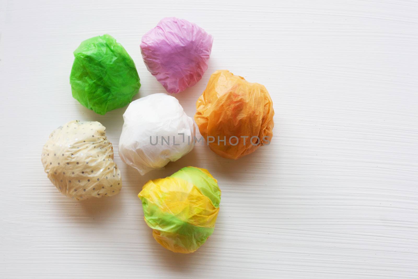 Colorful crumpled plastic bag on white background.