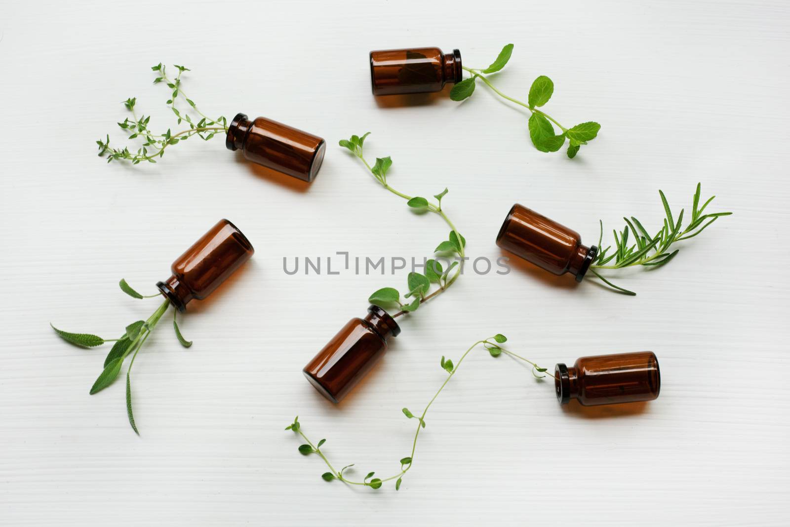 Top view, Bottle of essential oil with herbs