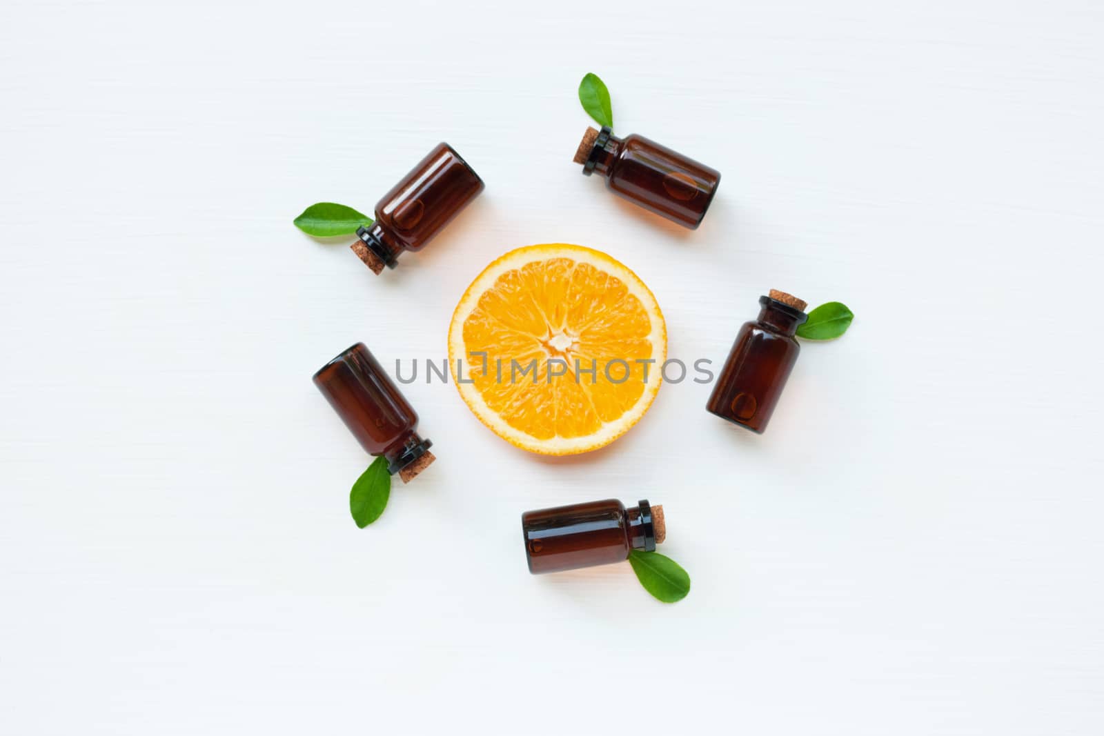 Bottle of essential oil from oranges citrus fruit on white background, Alternative medicine