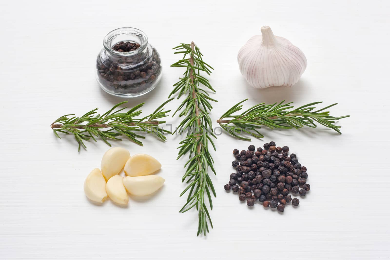 Garlic with rosemary and black peppercorn white background.