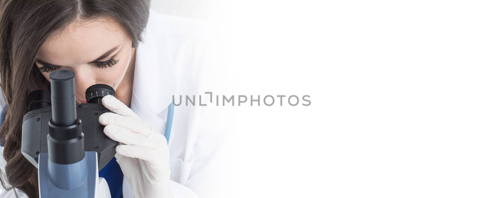 Female scientist working in a lab with microscope